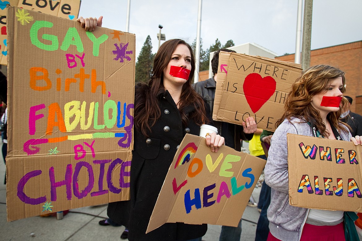SHAWN GUST/Press file 
Caitlin Boland, left, and Lynnsey Phillips, University of Idaho students, display homemade signs while wearing red tape over their mouths as they peacefully protest a 2010 visit to Coeur d&#146;Alene by members of Westboro Baptist Church.