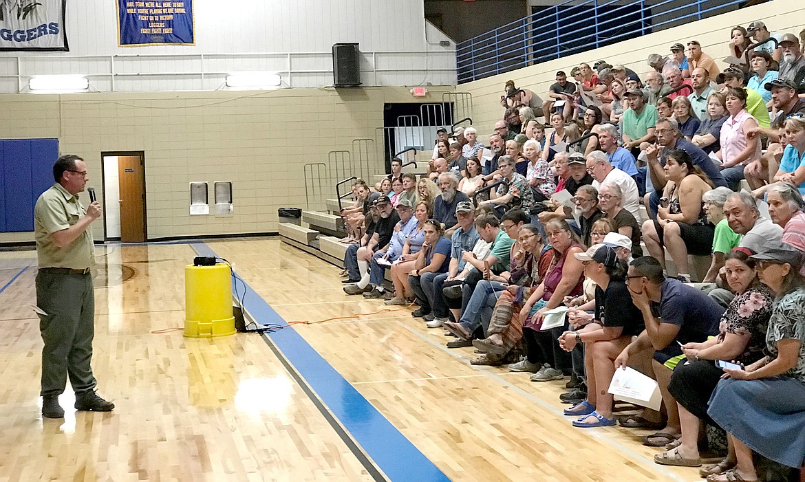 Kootenai National Forest Supervisor Chris Savage, left, speaks to a crowd of about 200 people dyring a public meeting at Libby High School Sunday afternoon, Sept. 3, 2017. The meeting addressed three wildfires facing Lincoln County. (John Blodgett/The Western News)