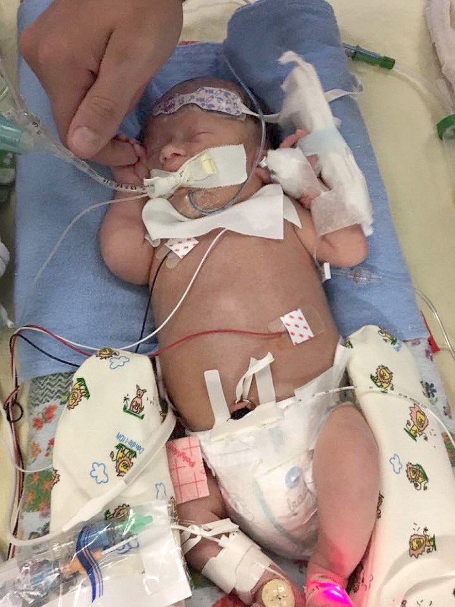 Jackson Stiffler holds his son Leroy&#146;s hand at Seattle Children&#146;s Hospital. (Courtesy of Joleen Beaubien)