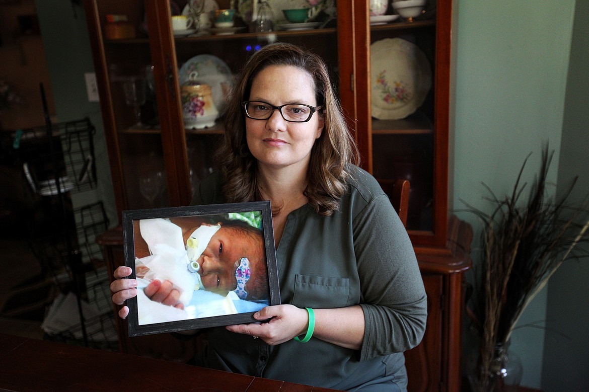 Joleen Beaubien, of Bigfork, holds a photo of her grandson, Leroy Stiffler, who is currently in Seattle receiving treatment for a rare genetic disease that has caused his veins to narrow and harden. (Mackenzie Reiss/Daily Inter Lake)