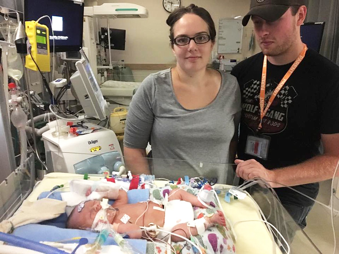 Brittany Ogle and Jackson Stiffler, both of Kalispell, pose for a photo with their son, Leroy Stiffler, who was born with a rare genetic disorder called generalized arterial calcification of infancy. The condition causes his veins to narrow and harden, forcing his heart to work very hard to pump blood throughout his body. (Courtesy of Joleen Beaubien)