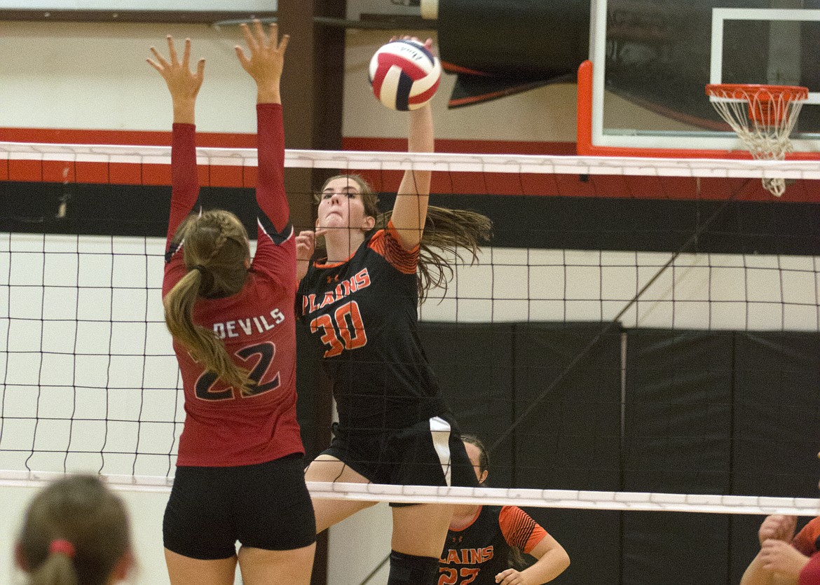 The Trotters&#146; Rachel Huenink spikes the ball past Noxon defender Anna Kaiser in Saturday&#146;s match. (Jeremy Weber/Clark Fork Valley Press)