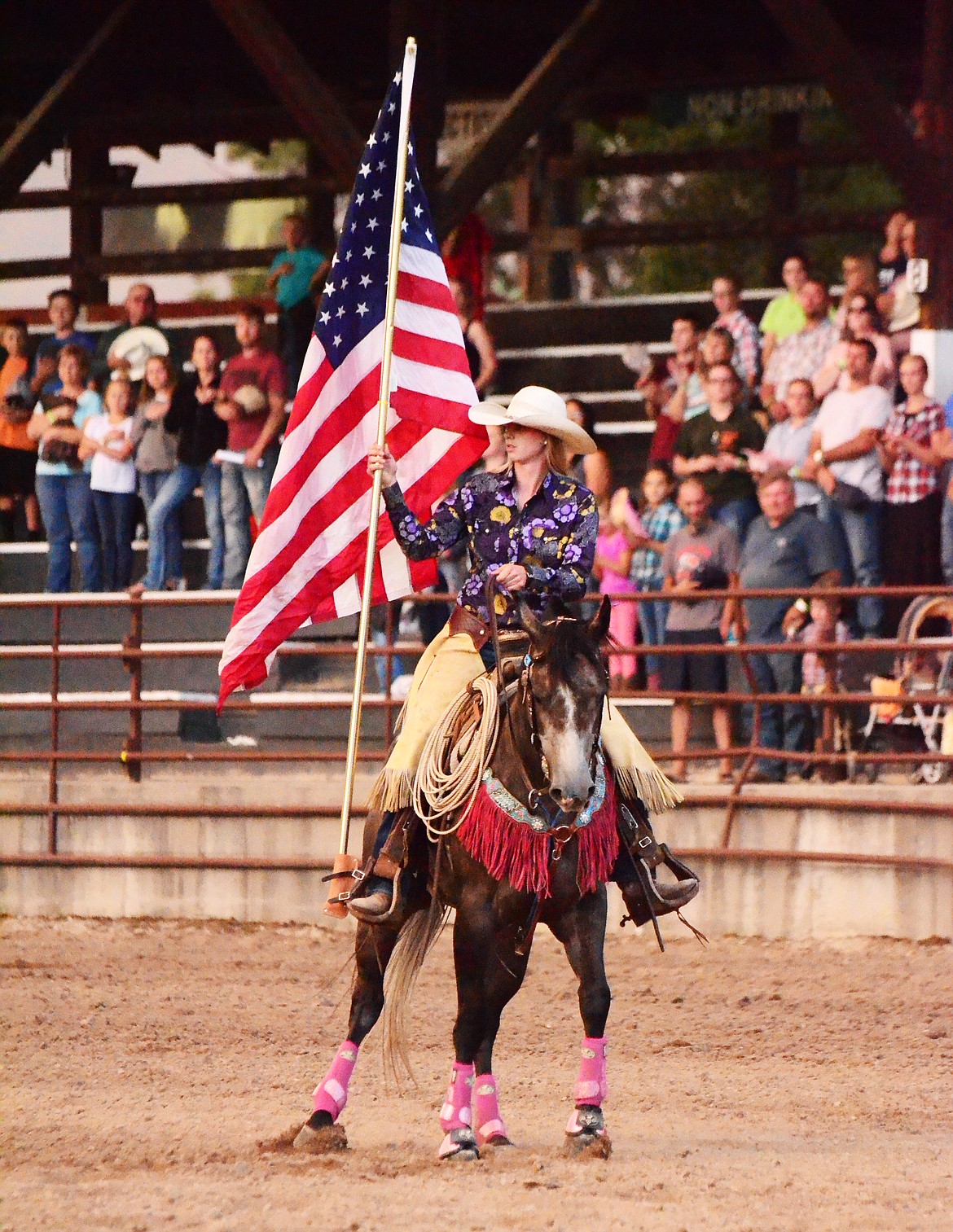 Thompson Falls native Paula Symington and her horse Hooey carried the American Flag each night of the rodeo. (Erin Jusseaume/ Clark Fork Valley Press)
