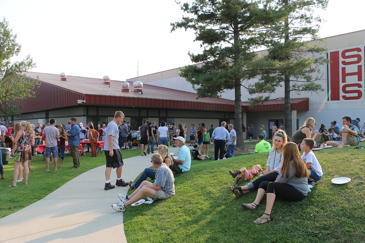 (Photo by MARY MALONE)
Incoming freshman, new students, family, friends and Sandpoint High School staff enjoyed a barbecue by the SHS parent group CARE before heading inside for the school's freshman and new student orientation Wednesday evening.