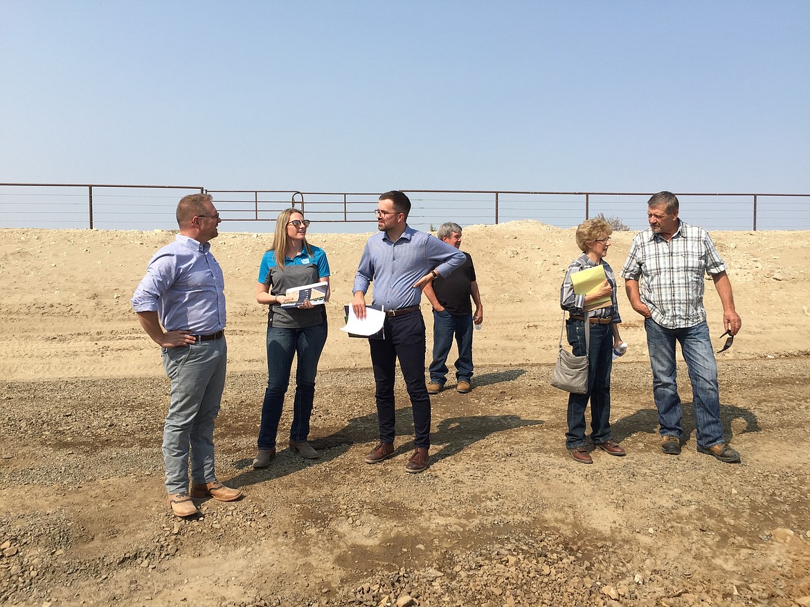 Molly Dickens/Courtesy photo - Blake Baldwin (third from left), Regional Outreach Rep with Governor Inslee's office, speaks with Dairy Farmers of Washington staff, Chelsi Riordan and Scott Kinney. Senator Shelly Short (far right) talks with a local farmer about the system.
