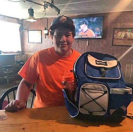 The boys back pack winner pictured here with his prize before donating it back to the school. (Photo obtained through Simple Simon&#146;s FB page)