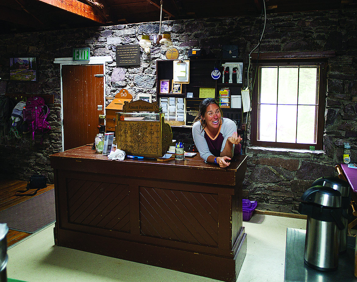 A worker stands behind the front desk at the Sperry Chalet in this file photo. The backcountry chalet in Glacier Park burned up Thursday in the Sprague Creek Fire. (Chris Peterson photo, Hungry Horse News)