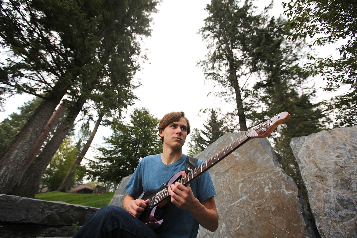 Port Nugent, 16, of Whitefish, finds a quiet spot at Flathead Lake Lodge after a class at the Crown of the Continent Guitar Workshop on Tuesday afternoon. (Mackenzie Reiss photos/Daily Inter Lake)