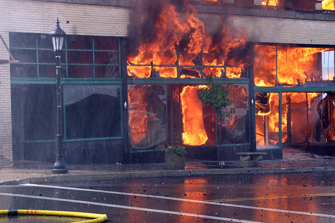 Photo by JOSH MCDONALD
Flames shoot out of the front windows before the collapse.