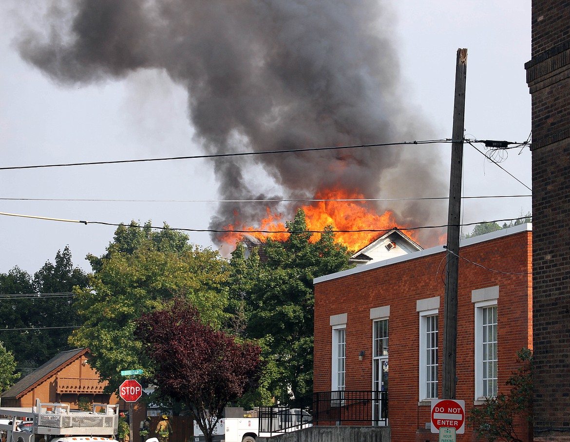 Left: The rooftop of Patrick&#146;s Steakhouse on Division Street catches fire at approximately 3:14 p.m.
Photo by
JOSH MCDONALD
Middle: Crews from Mullan Volunteer Fire Department attack the east side of the Steakhouse with water.

Right: What remains of the Steakhouse Wednesday morning.
Photos by
CHANSE WATSON