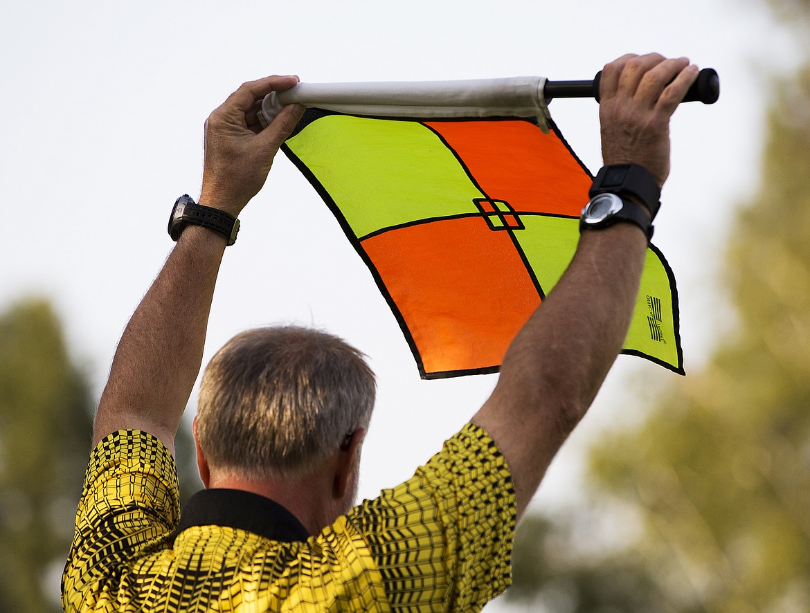 LOREN BENOIT/PressAn official raises a flag.