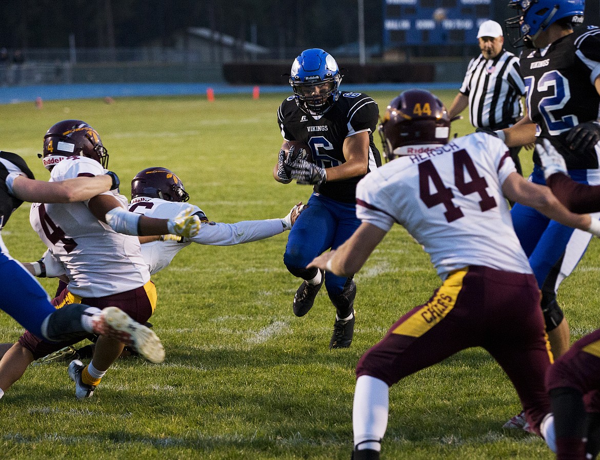 LOREN BENOIT/PressCoeur d'Alene's Shilo Morgan rushes the ball towards the goal line during Friday night's game at Coeur d'Alene High School.