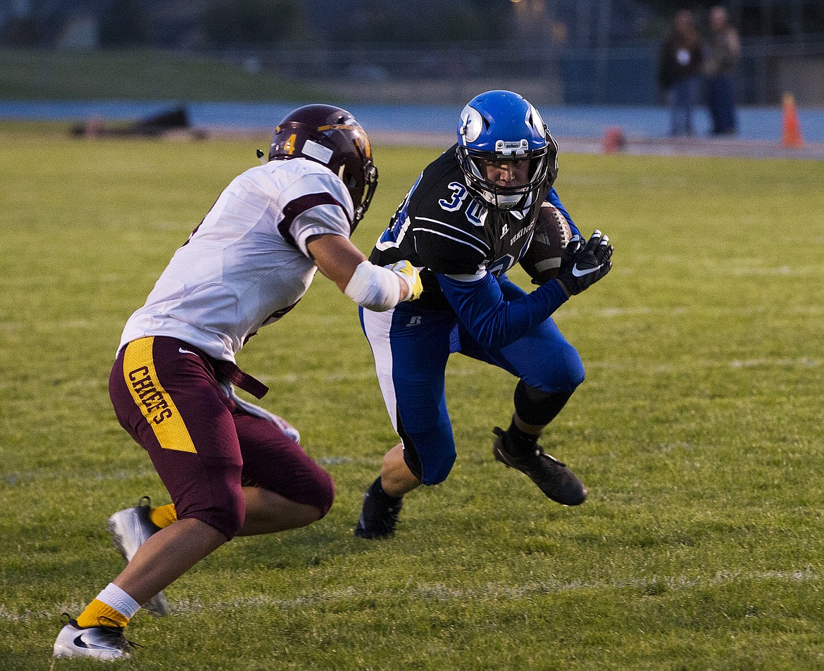 LOREN BENOIT/PressCoeur d'Alene's Caleb Beggerly rushes the ball against Moses Lake on Friday.