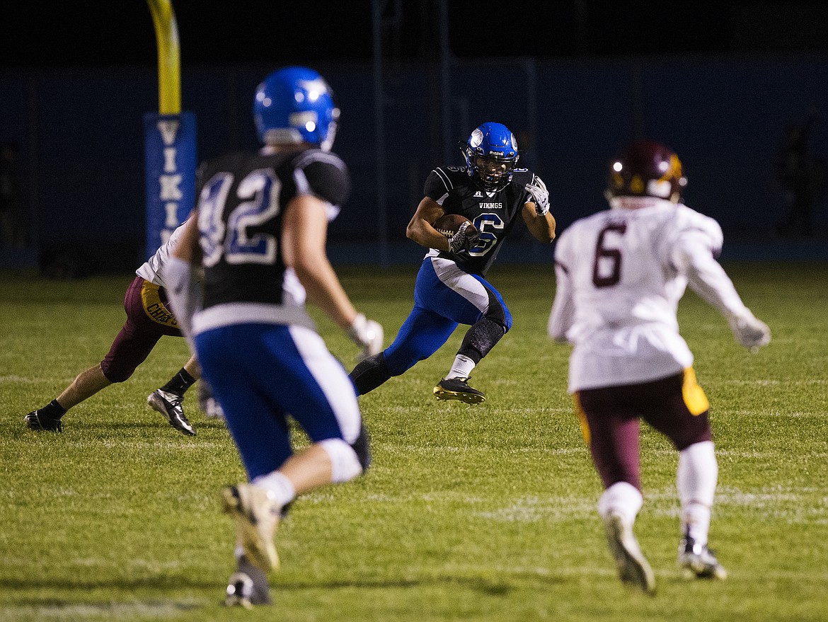 LOREN BENOIT/PressCoeur d'Alene running back Shilo Morgan rushes the ball during Friday's game against Moses Lake High School. Morgan had two touchdowns in the Viking's 35-7 win over the Chiefs.