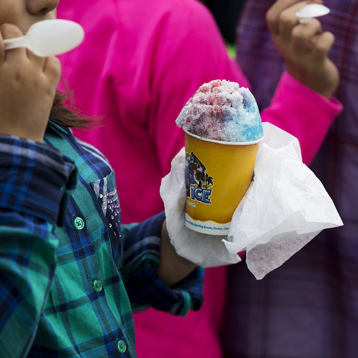 LOREN BENOIT/PressA Winton Elementary student enjoys a shaved ice Friday morning at school.