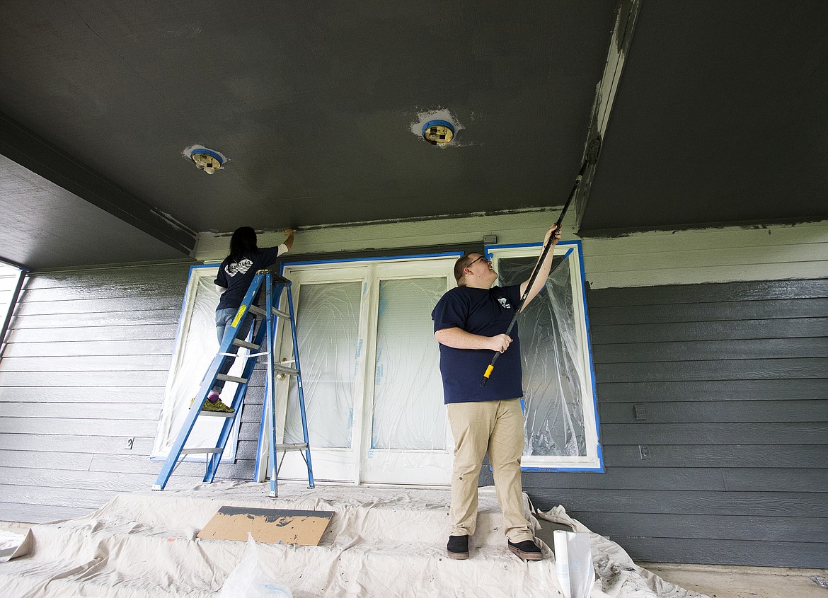 Photos: LOREN BENOIT/Press
Mel Dowd and Cory Punton, both with Mountain West Bank, volunteer their time to paint the Moyer Home at Children&#146;s Village Thursday afternoon in Coeur d&#146;Alene. Around 80 volunteers deep-cleaned the inside of homes, landscaped and chopped wood around the 15-acre Children&#146;s Village campus.