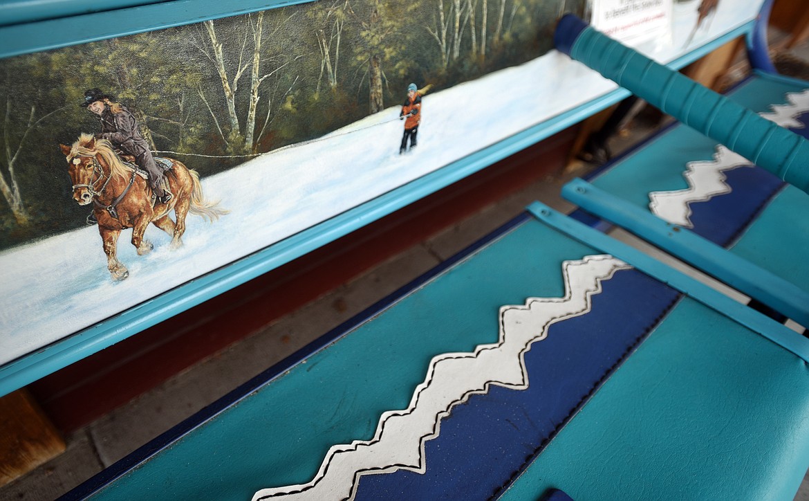 A ski lift chair by artist Dee Dee Cooper sits outside Frame of Reference in downtown Whitefish.