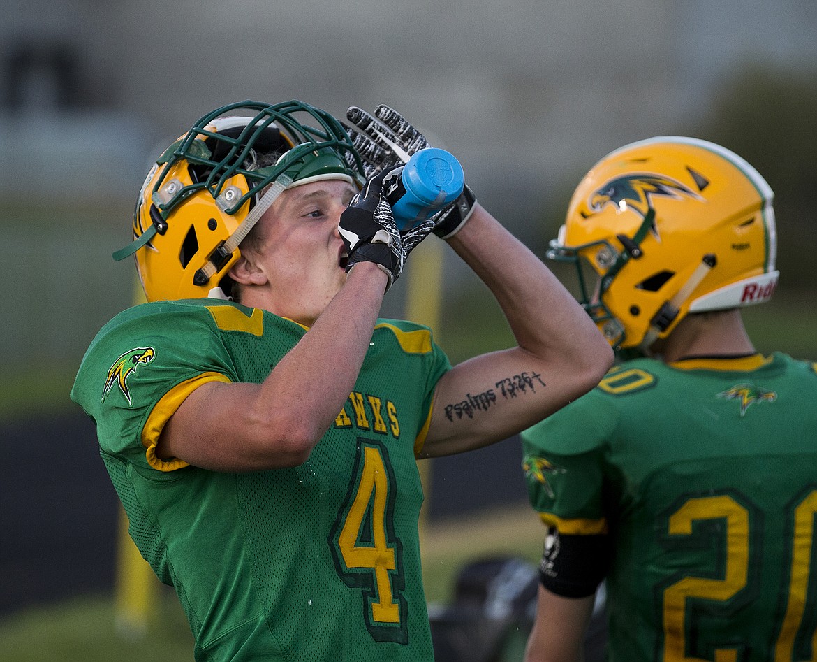 LOREN BENOIT/Press
Christian Suko takes a swig of water after coming off the field.