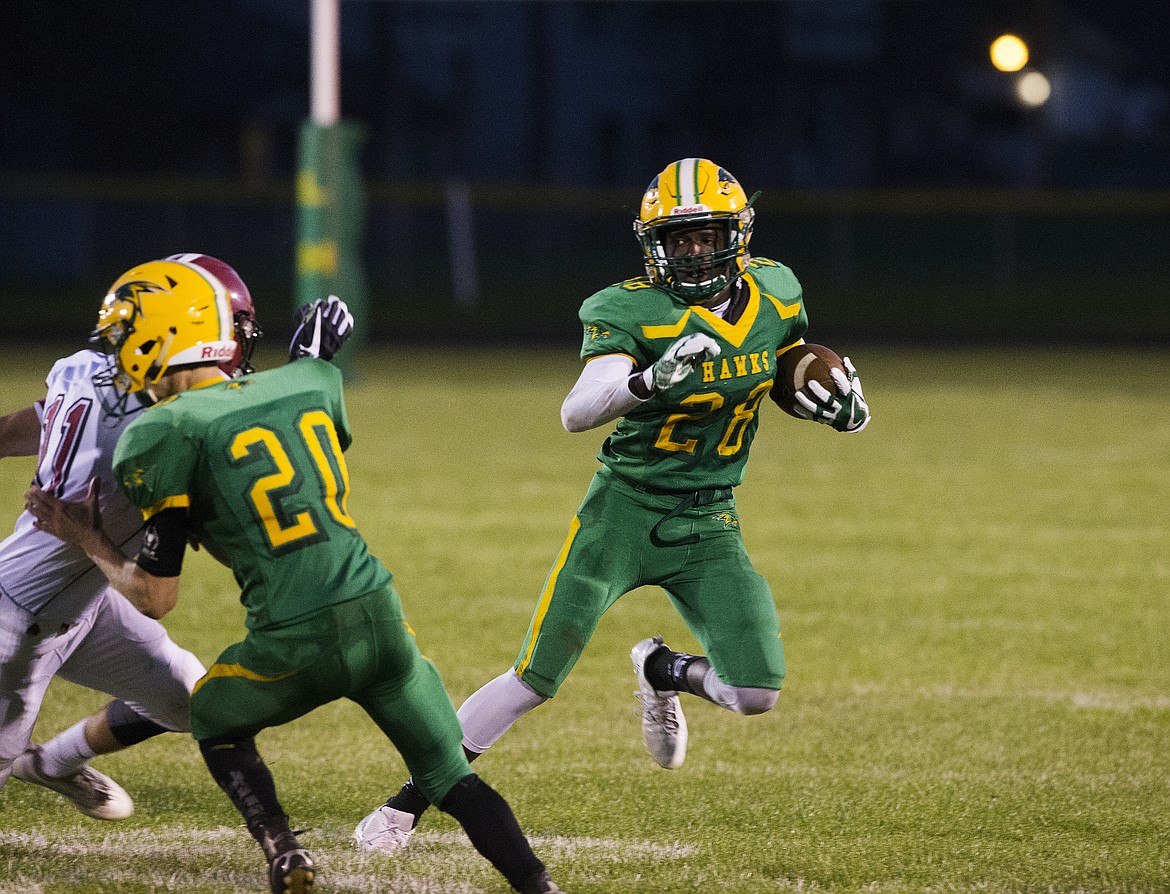 LOREN BENOIT/Press
Lakeland&#146;s Trey McArthur runs around a block in a game against Colville on Sept. 1.