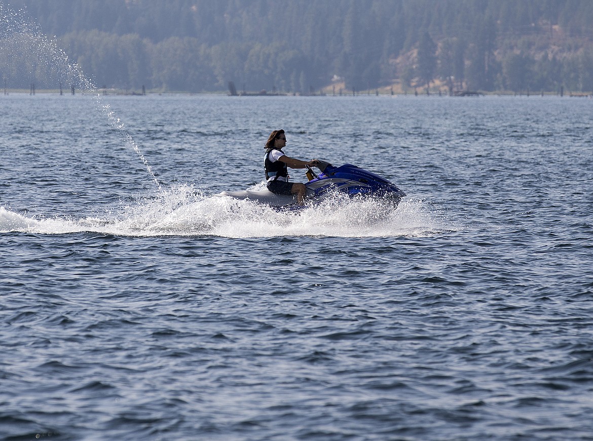 LOREN BENOIT/PressA jetskier skips across the water on Lake Coeur d'Alene on  Tuesday.