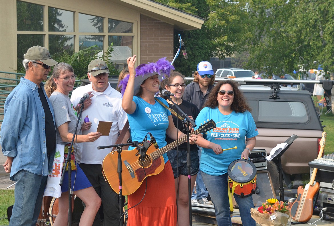 Deidre Corson leads a group from North Valley Music School as they sing the school&#146;s jingle for the Great Fish Community Challenge Saturday during the Whitefish Community Foundation&#146;s Nonprofit Fair at Depot Park. As part of this year&#146;s Great Fish Community Challenge, nonprofits are competing in a Jingle Competition. Finalist performed their jingles Saturday for the chance to be awarded a $1,000 grant at the Great Fish Awards event Oct. 12. (Heidi Desch/Whitefish Pilot)