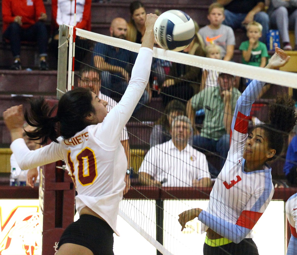 Rodney Harwood/Columbia Basin Herald
Moses Lake middle hitter Yasmin Shateri (10) goes up to block Eastmont's Britt Vaughn's shot during the second set of Tuesday's Big Nine season opener.  The Chiefs came from two games down to win in five games.