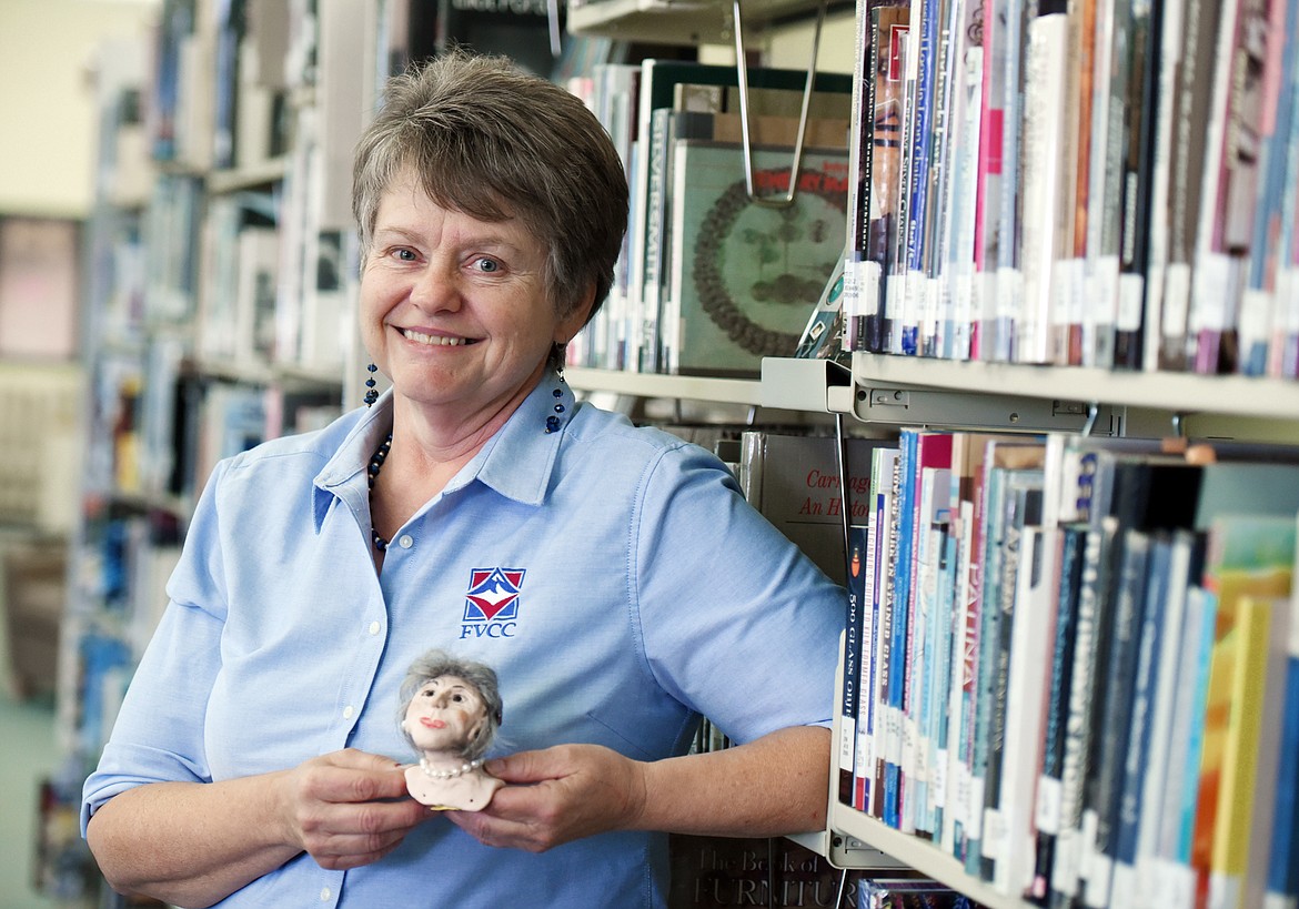 Flathead Valley Community College library tech Sinda Puryer with one of the small clay characters she creates from her own imaginings on Aug. 23 at FVCC. This is one she dubbed &#147;The Opera Singer.&#148; (Brenda Ahearn photos/Daily Inter Lake)