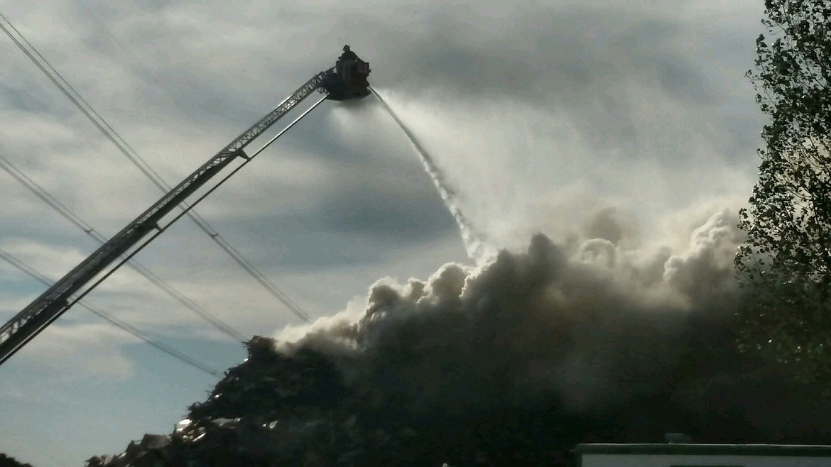 Photo courtesy NORTHERN LAKES FIRE DISTRICT
A firefighter unleashes the power of a hose truck on a fire at Site Solutions in Athol on Sunday afternoon.