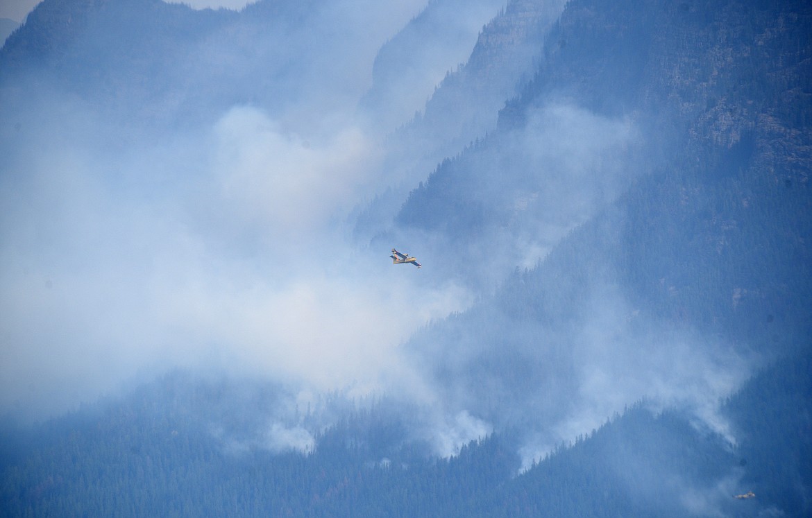 A super scooper flies into position to drop water on the Sprague Fire in Glacier National Park on Sunday. (Aaric Bryan/Daily Inter Lake)