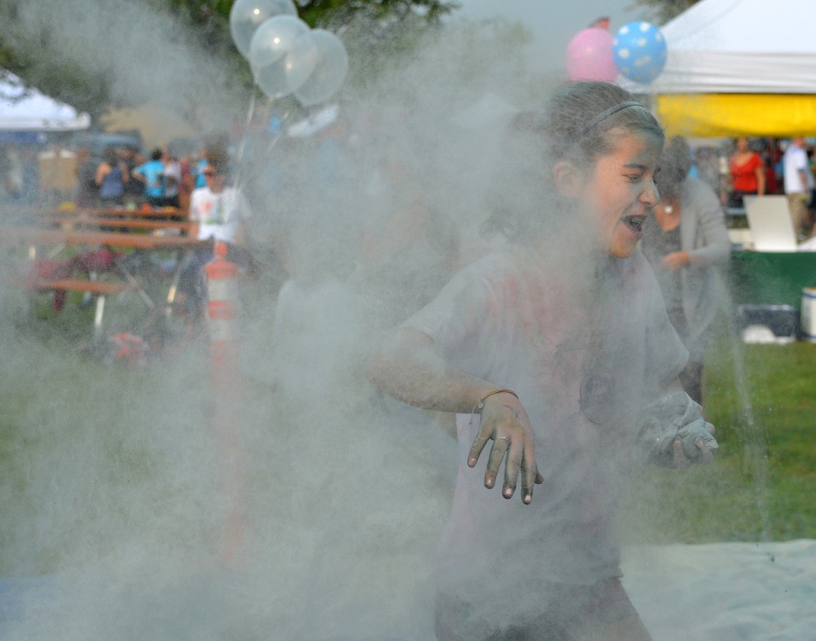 A girl gets hit by colored powder Saturday during the color toss at Depot Park for the Whitefish Community Foundation Color Run and Nonprofit Fair. The Color Run was turned into a color toss because of poor air quality due to wildfire smoke. (Heidi Desch/Whitefish Pilot)