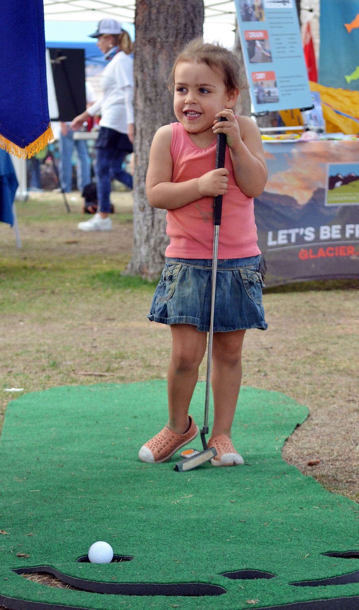 Sage McElwain, 3, smiles after sinking a put at the Whitefish Rotary Club booth Saturday during the Whitefish Community Foundation&#146;s Nonprofit Fair at Depot Park. (Heidi Desch/Whitefish Pilot)