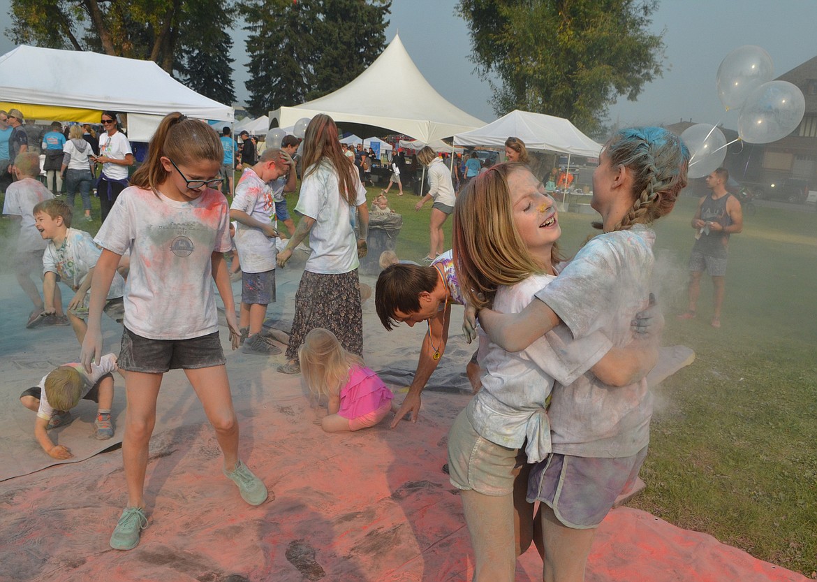 The Whitefish Community Foundation&#146;s Color Run for the Great Fish Challenge turned into a colored powder fight Saturday at Depot Park after the run was canceled due to poor quality because of wildfire smoke. (Heidi Desch/Whitefish Pilot)