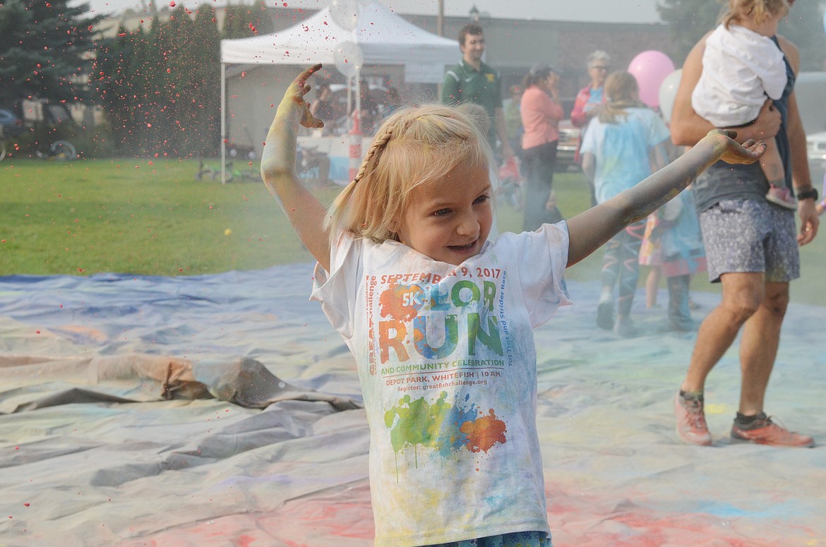 Sarah Bott, 5, plays in the color during the color toss Saturday at Depot Park during the Whitefish Community Foundation&#146;s Color Run and Nonpfrofit Fair. (Heidi Desch/Whitefish Pilot)