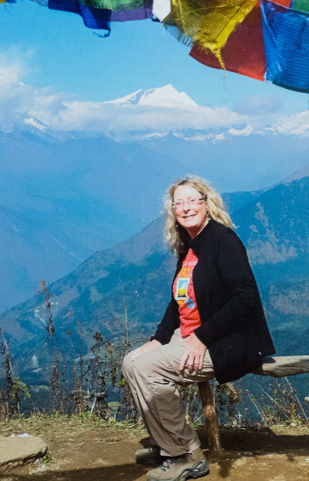 Janice Haller poses in front of a towering mountain during a trip to Nepal. (Photo courtesy of Janice Haller)