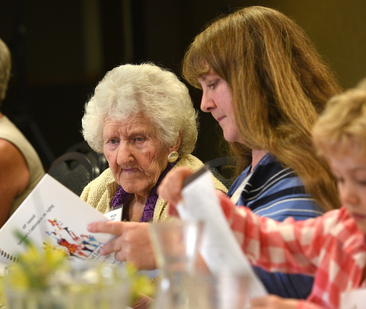 Helen Self, 108, looks over the program for the Governor&#146;s Conference with her granddaughter Diane Gunther. (Aaric Bryan/Daily Inter Lake)