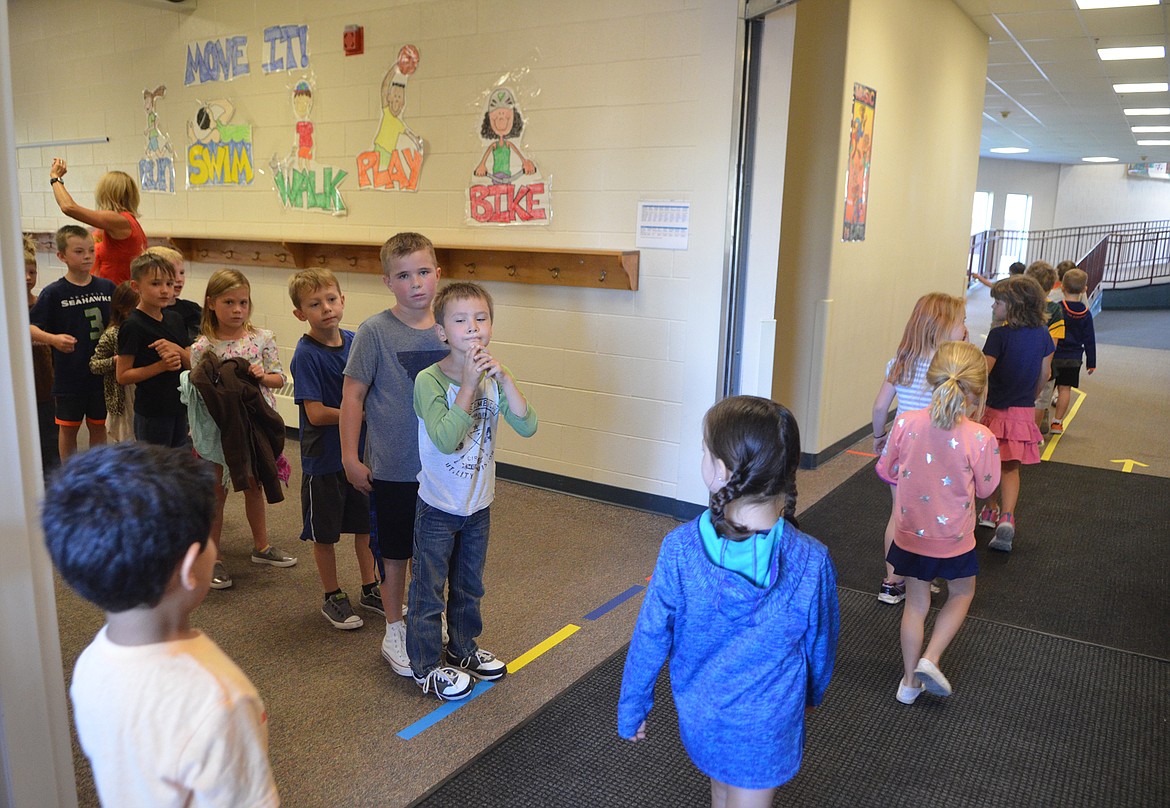 One classroom of students passes through the area known as &#147;dysfunction junction&#148; while another classroom room waits its turn on a recent morning inside Muldown Elementary. The narrow area, where three hallways and an outside entrance all come together, is often congested as students try to walk between the gym, classrooms and enter the school from the playground. (Heidi Desch/Whitefish Pilot)