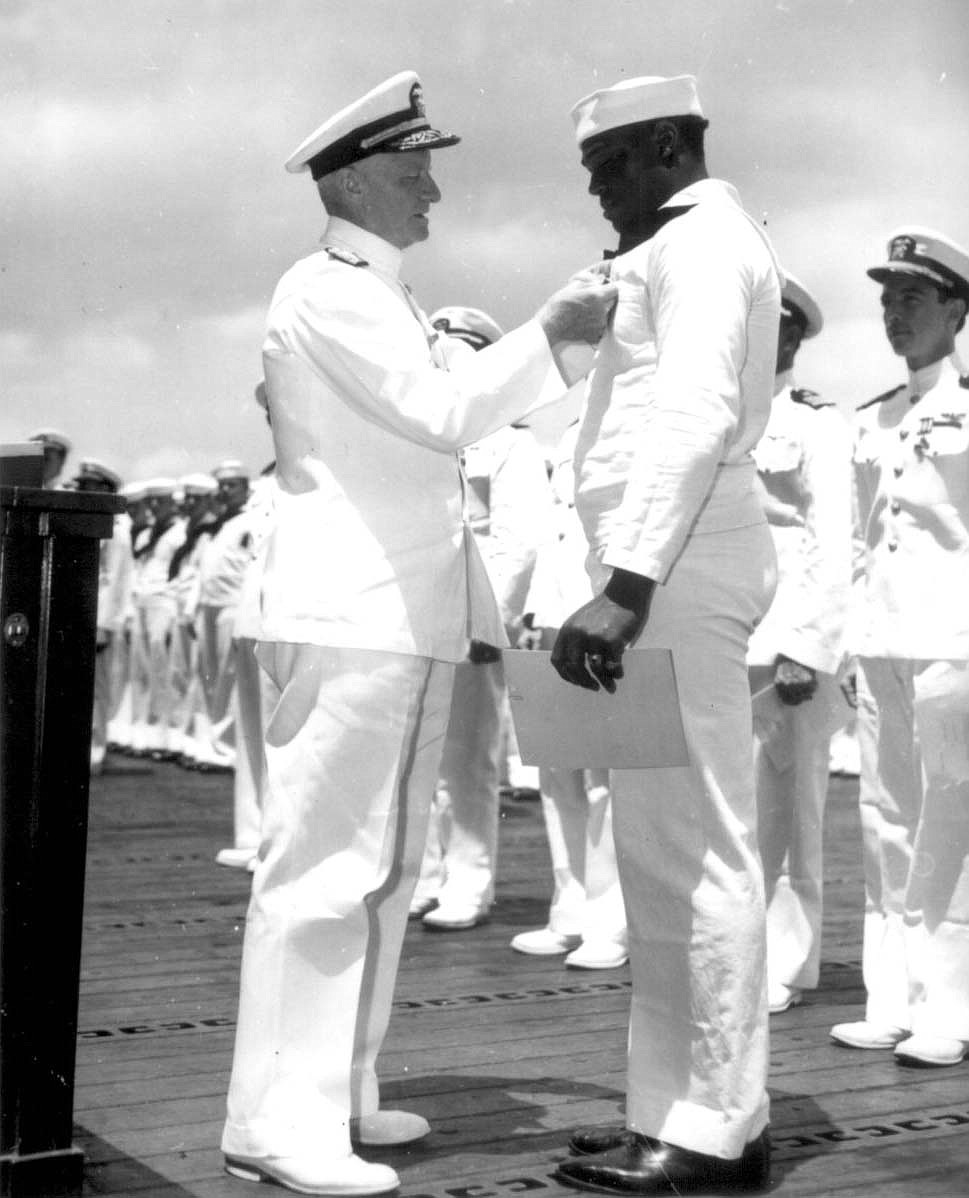 U.S. NAVY PHOTO
Admiral Chester W. Nimitz pins Navy Cross on Doris &#147;Dorie&#148; Miller, at ceremony on board the USS Enterprise (CV-6) at Pearl Harbor, May 27, 1942.