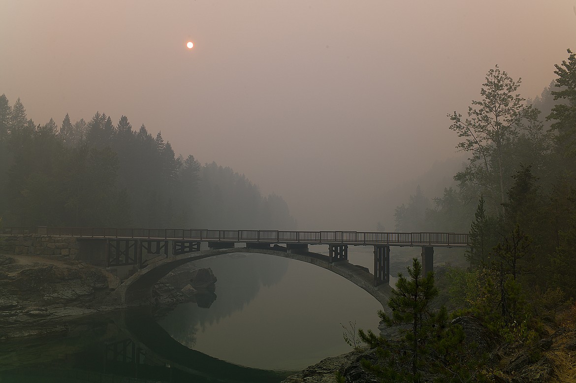 Thick smoke last week obscured the setting sun over the Belton Bridge in West Glacier. Conditions have dramatically improved in the past few days. (Chris Peterson photo)