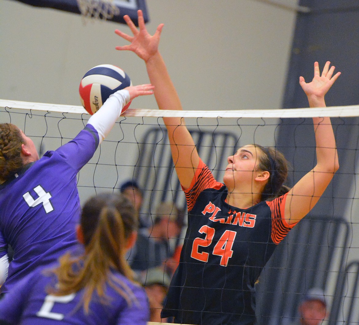 Plains middle blocker Kara Altmiller (24) attempts to block a Charlo players attack during Saturday afternoon&#146;s match at Charlo High School. Plains defeated Charlo, 25-21, 15-25, 25-9, 25-14. (Jason Blasco/Special to the Clark Fork Valley Press)