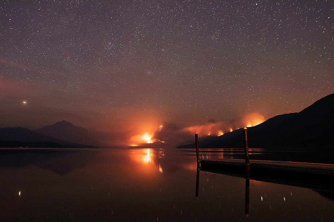 Millions of stars glow above the Sprague Fire in Glacier National Park Monday evening at the boat dock in Apgar.