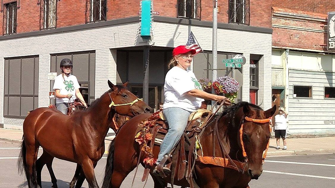 (right) Leslee Stanley, local 4-H President, and another 4-H member bring horses back to the streets of Wallace.