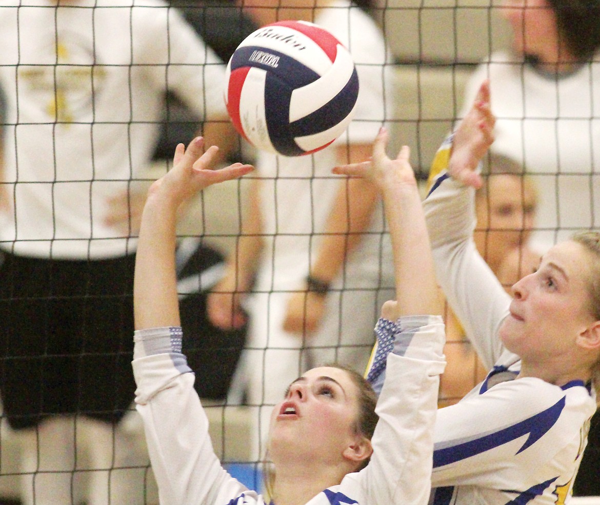 Junior Alli Collins sets as Jessika Jones approaches for a kill shot in third game vs. Polson Saturday afternoon. (Paul Sievers/The Western News)