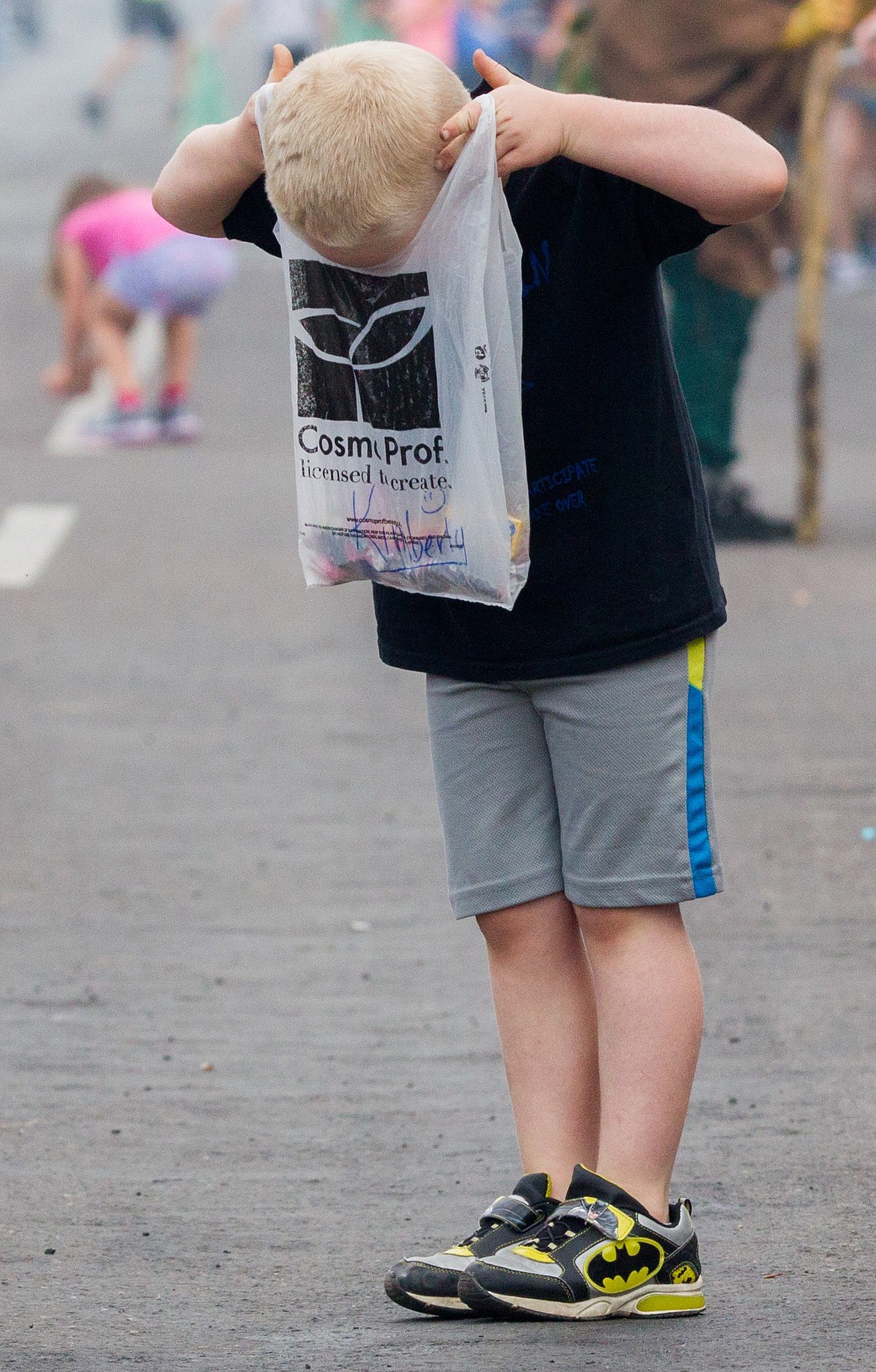 Bridger Rebo surveys the candy he chased down during the 2017 Nordicfest Heritage Festival parade on Saturday, Sept. 9, 2017. (John Blodgett/The Western News)