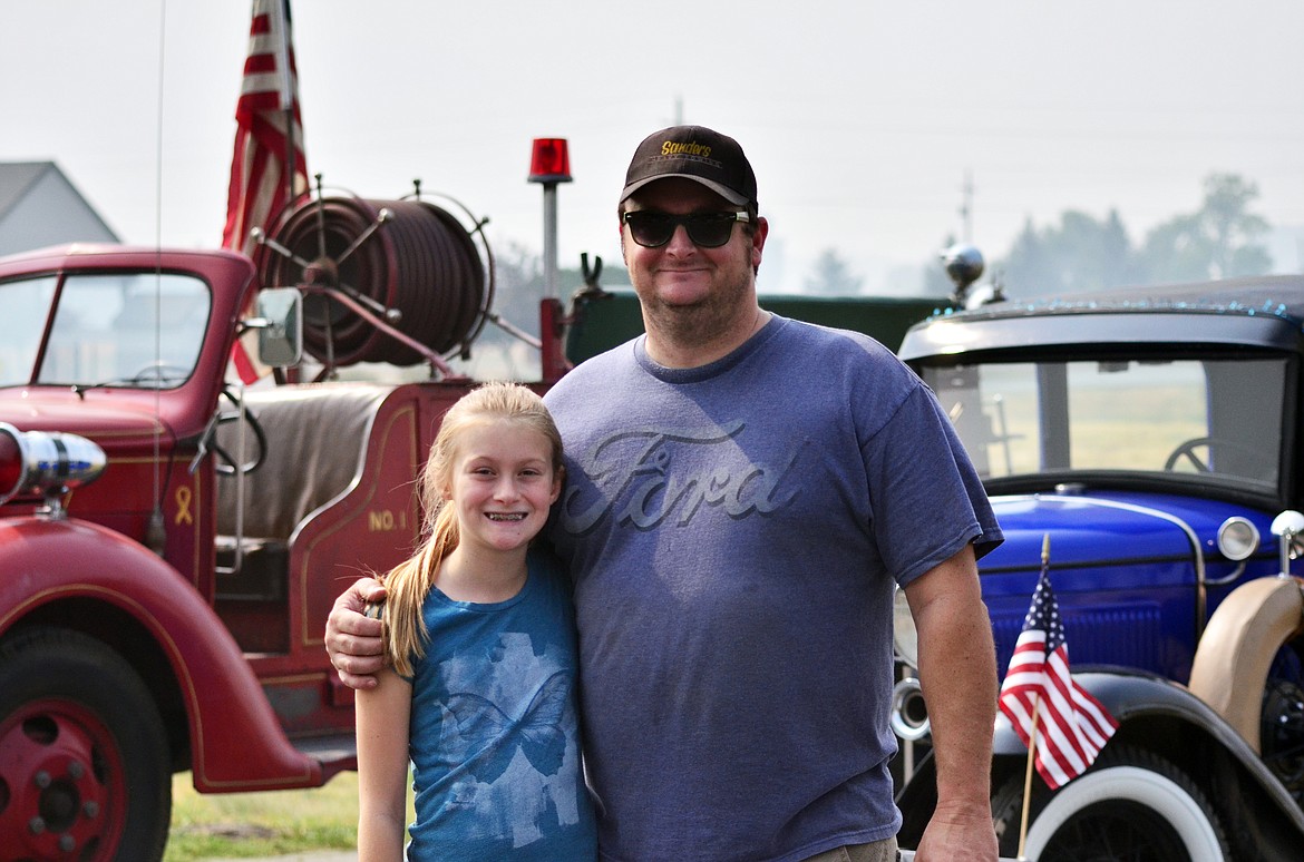 Ken and Teagan Saner havnig a look at the other exhibitors during the event. Ken had three classics showcased on the day. (Erin Jusseaume/ Clark Fork Valley Press)