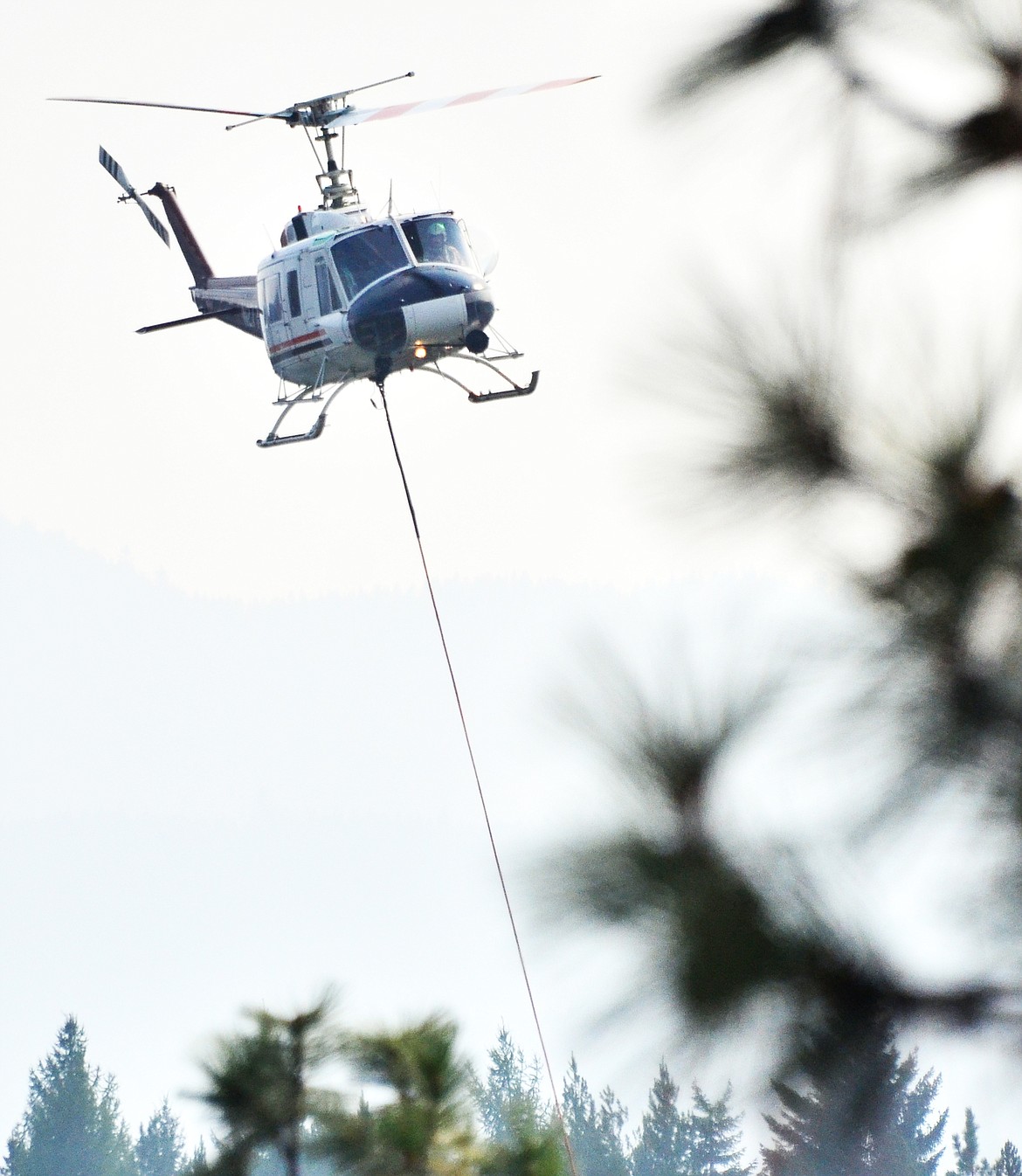 Air attack on Deep Creek Saturday September 9, dipping from the Clark Fork River one mile from the Heli-base on Blue Slide Road. (Erin Jusseaume/Clark Fork Valley Press)