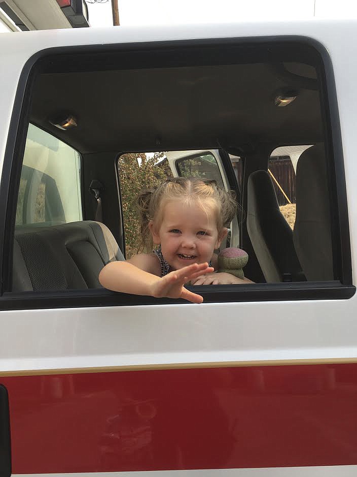 Hayden Hout waves from a fire truck at the St. Ignatius Volunteer Fire Department openhouse over the weekend. (Photo courtesy of the St. Ignatius Volunteer Fire Department)