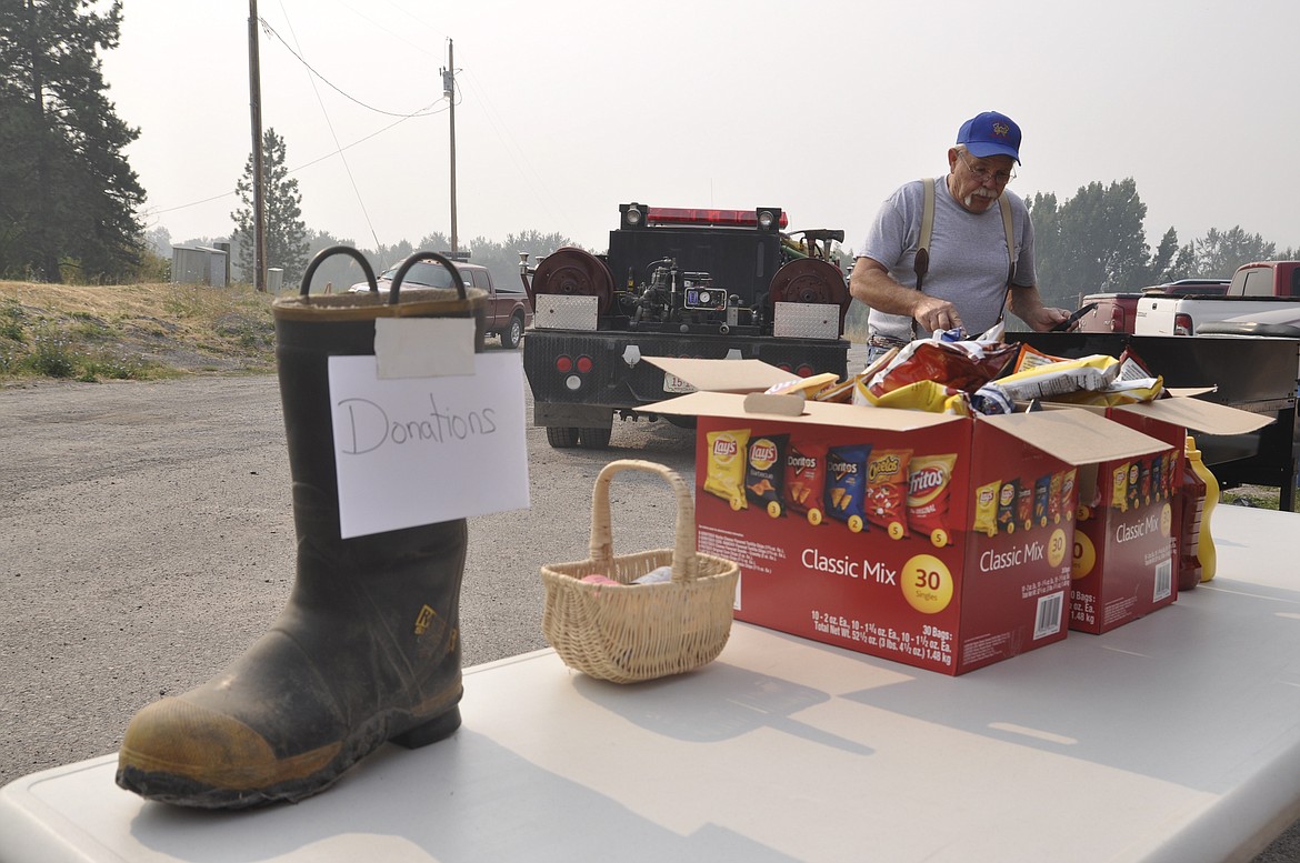 Bob Brannan of the St. Ignatius Volunteer Fire Department, mans the grill during an openhouse on Saturday, Sept.9. Hot dogs, hamburgers and other treats were available for those who stopped by. (Ashley Fox/Lake County Leader)