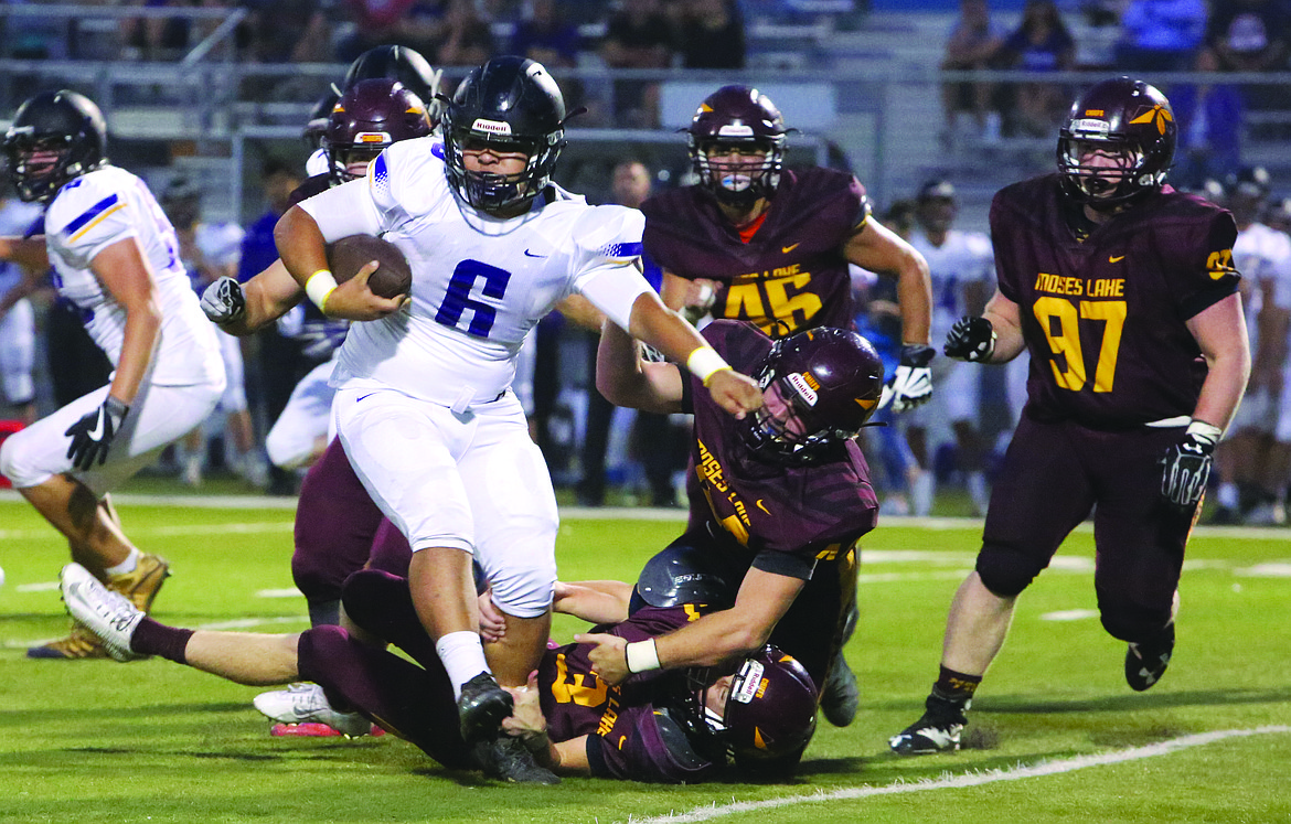 Connor Vanderweyst/Columbia Basin Herald
Moses Lake defenders swarm to tackle Hanford's Drezdyn O'Daol.