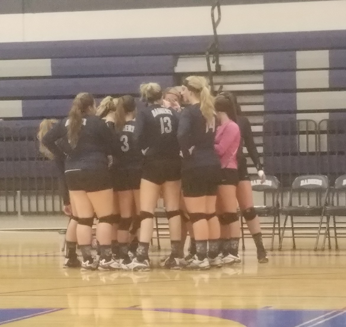 The Bonners Ferry varsity volleyball team huddles during its match against Clark Fork.