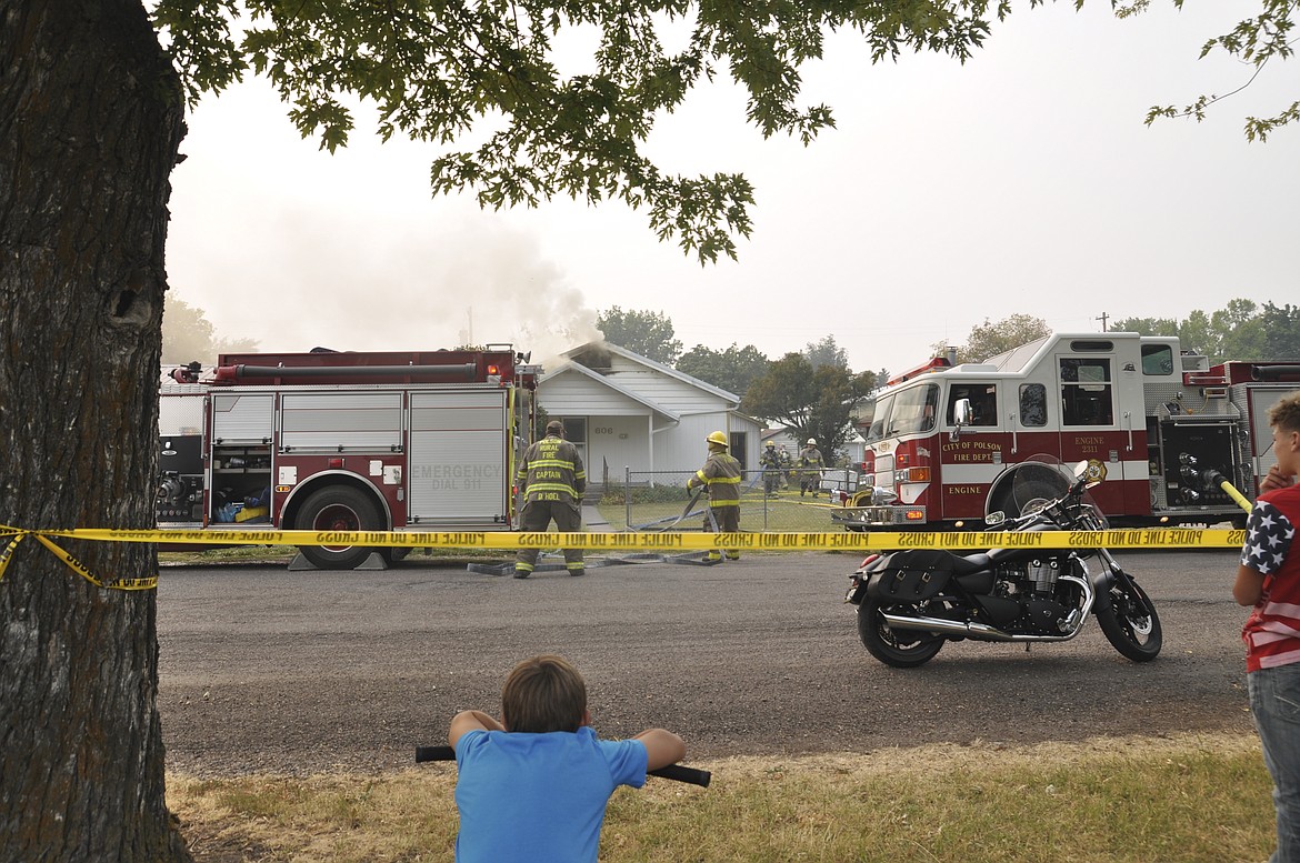 Neighbors were able to safely watch crews as they worked to extinguish a house fire in Polson on Sept. 6. (Ashley Fox/Lake County Leader)